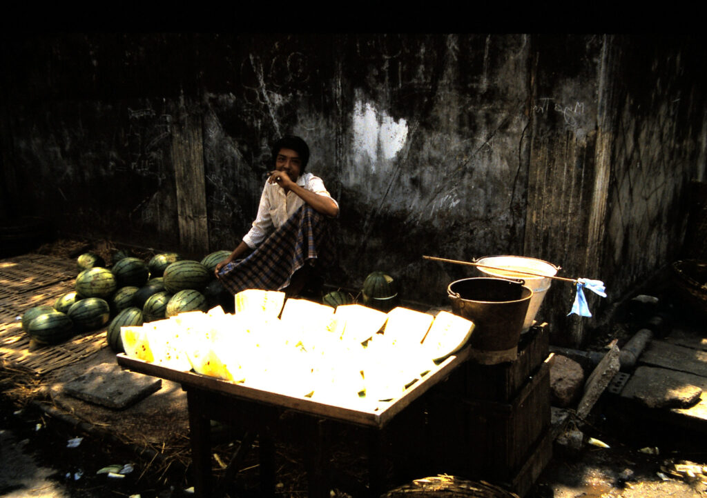  IN RANGUN 1985 SOME YELLOW WATERMELONS IN THE MARKET STAND 